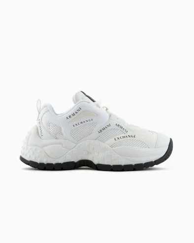 White mesh sneakers with contrasting logo lettering and high running sole.